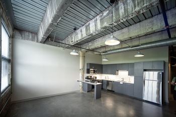 a kitchen with gray cabinets and a white refrigerator